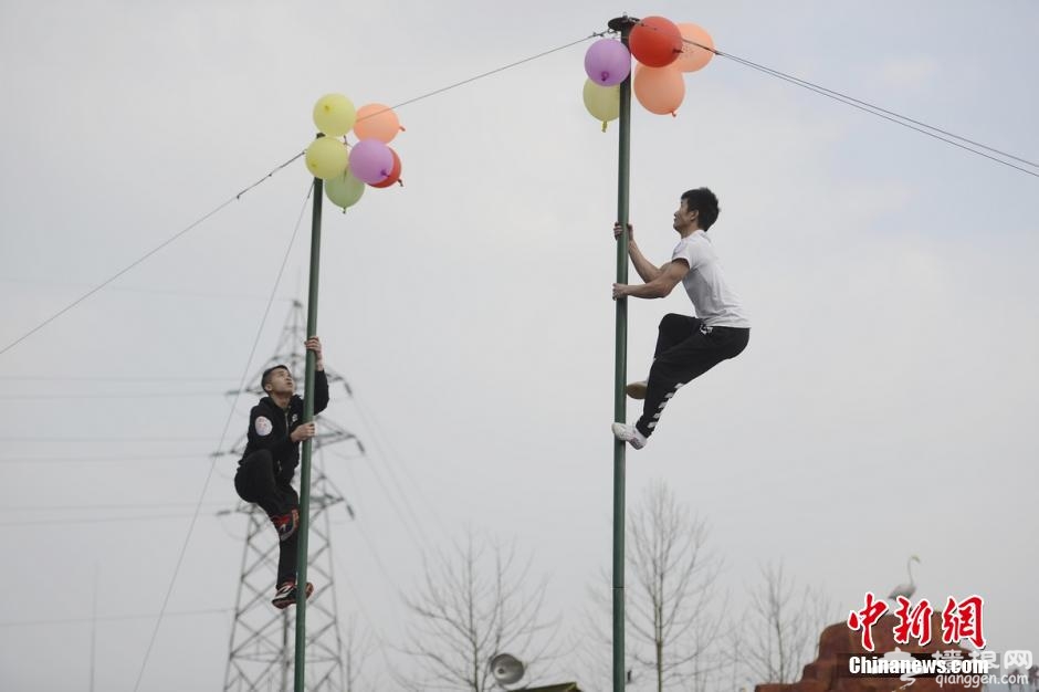 湖南宁乡灰汤举办爬杆比赛 美女泳衣上阵[墙根网]